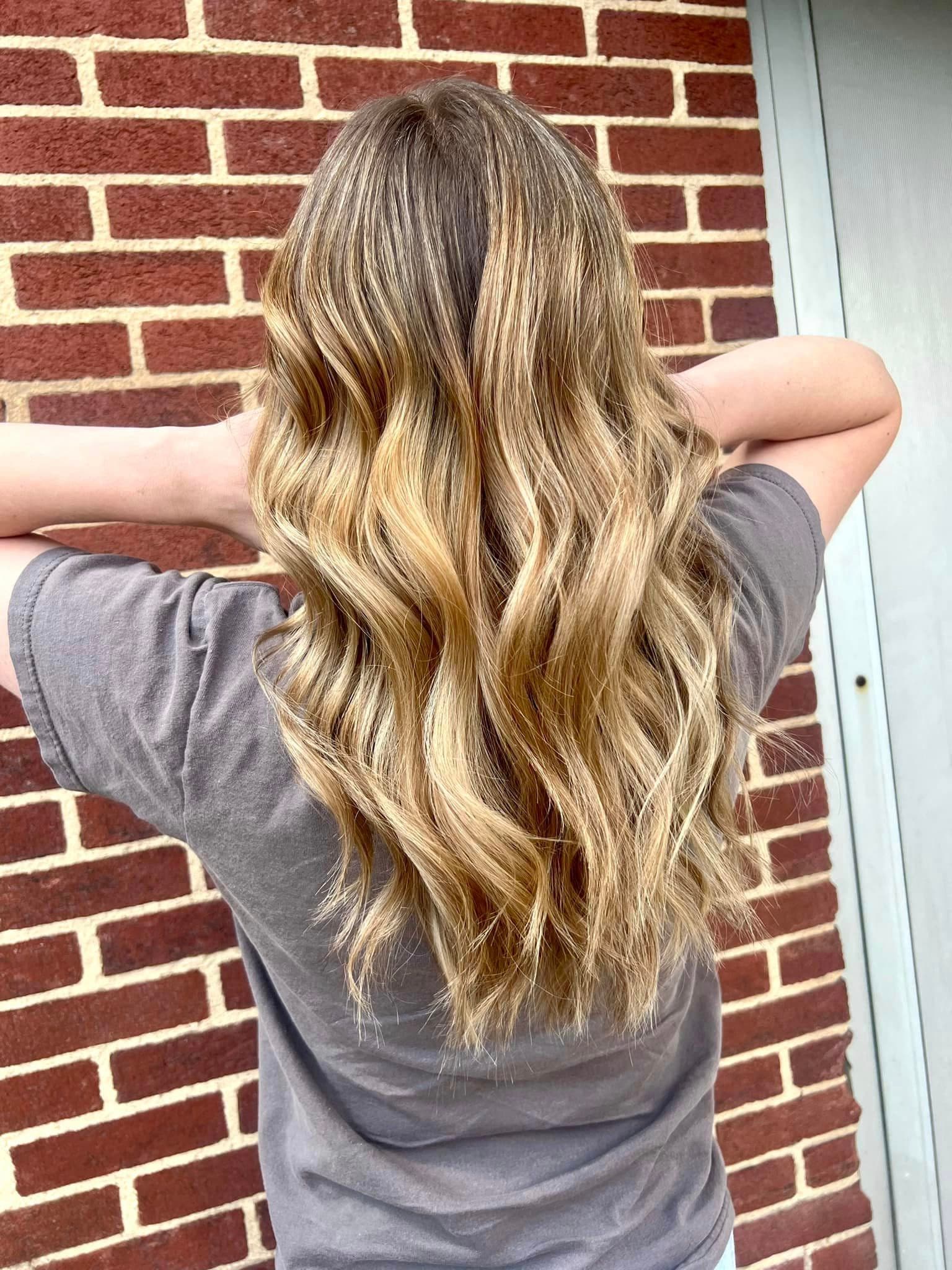Long wavy blonde balayage by Hair Mafia Salon